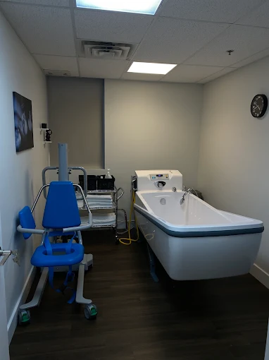 Inside a Freedom Bathing Care treatment room, showing the accessible tub and lift chair
